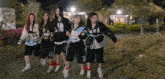 a group of girls are walking down a sidewalk and one of them has a number 19 on her shirt