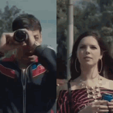 a man is taking a picture of a woman with a camera and a woman is holding a drink .