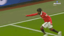 a soccer player in a red shirt with the number 26 on it