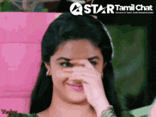 a woman covering her face with her hand with a star tamil chat logo in the corner