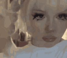 a close up of a woman 's face with a blurred background .