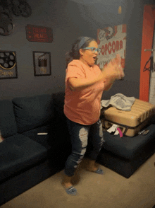 a woman is dancing in front of a popcorn poster