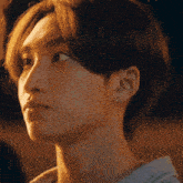 a close up of a person 's face with their eyes looking up