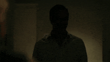 a man with a mustache is in the dark