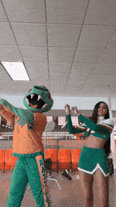 a cheerleader and a mascot are dancing together