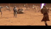 a man is holding a lightsaber in front of a group of people .