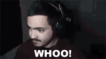 a man wearing headphones is making a funny face .