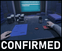 a person is sitting at a desk with a confirmed sign above them
