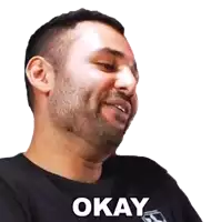 a man with a beard wearing a black shirt that says okay on it
