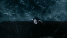 a woman in a white dress is standing in the water