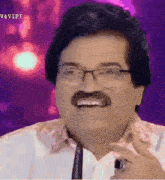 a man with glasses and a mustache is smiling in a purple background