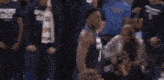 a basketball player wearing a minnesota jersey is running on the court .