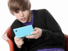 Boy Looking At Nintendo Ds In Disgust Nintendo Ds GIF - Boy Looking At Nintendo Ds In Disgust Nintendo Ds Ew GIFs