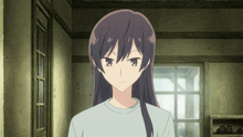 a girl with long black hair is standing in a room
