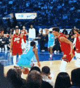 a basketball game is being played in front of a crowd wearing all star uniforms