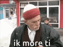 an elderly man wearing a red and white turban says ik more ti