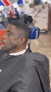 a man is sitting in a barber chair with his eyes closed .