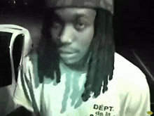 a man wearing a hat and a shirt that says dept on it
