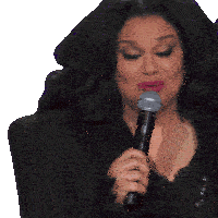 a woman in a black jacket is holding a microphone in her hand