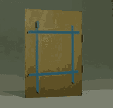 a cardboard box is sitting on top of a table with a blue tape .