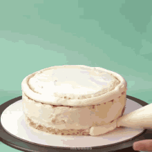 a person is frosting a cake with a piping bag that says mr. chungo