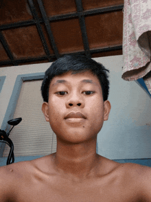 a young man without a shirt is taking a picture of himself
