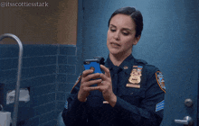 a woman in a police uniform holds a cell phone and says still porn
