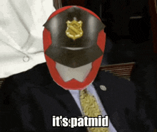 a man in a suit and tie with a red helmet on his head and the words it 's patmid