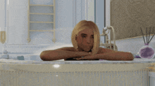 a woman is laying in a bathtub with a bottle of perfume in the background