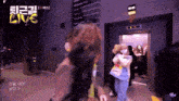 a group of people are standing in front of an elevator with the words live on the bottom