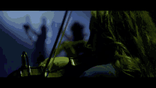 a woman is playing a violin in a dark room with a blue background