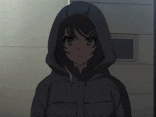 a girl wearing a hooded jacket is standing in the dark