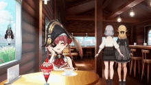 a girl in a pirate hat sits at a table with a cup of tea and a strawberry dessert