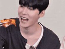 a close up of a person eating a piece of food with chopsticks
