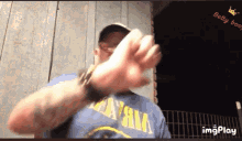 a man wearing a blue shirt that says nirvana is giving the middle finger