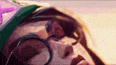 a close up of a person 's face with glasses