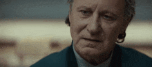 a close up of a man 's face with a serious expression