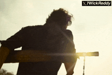 a silhouette of a man with a sign that says x7wick reddy on it