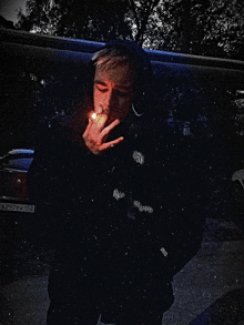 a man is smoking a cigarette with a license plate that says a29786k