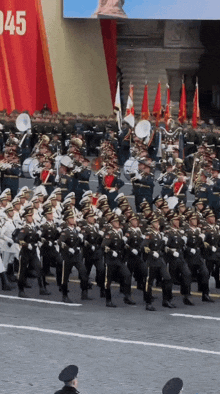 soldiers marching in front of a sign that says 1945