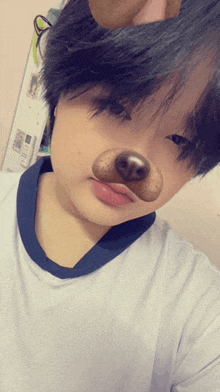 a girl with a dog nose on her face taking a selfie