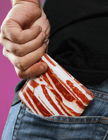 a person pulls a wallet out of their back pocket that looks like bacon