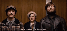 three people are standing in an elevator and one of them says she 's going to find out .
