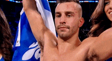 a shirtless man is holding a blue and white flag in his hands