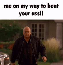 a man in a black jacket is walking down a street with the words " me on my way to beat your ass " on the bottom
