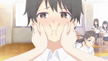 a boy making a face with his hands in front of his face