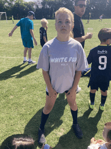 a girl wearing a white fox vol 3 shirt