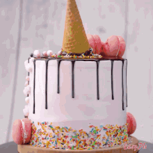 a cake with a waffle cone on top and sprinkles on the bottom