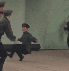a group of soldiers are dancing together on a stage .