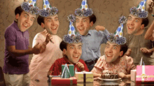 a group of people wearing party hats are celebrating a birthday party